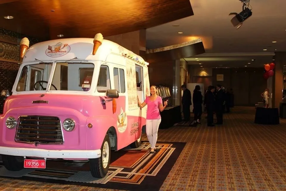 Front view of the classic pink and white ice cream van displayed inside Crown Casino